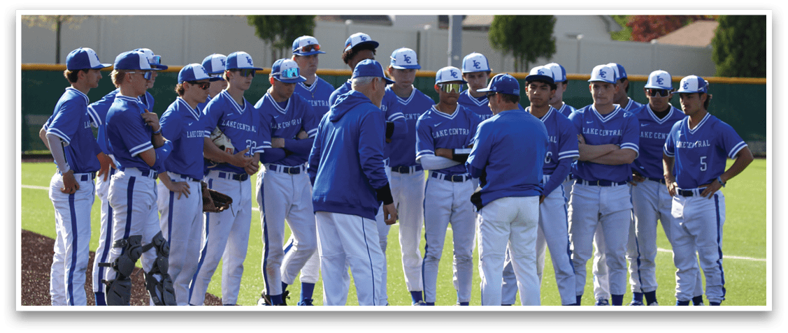 A group of baseball players wearing blue and white uniforms. Description generated by AI