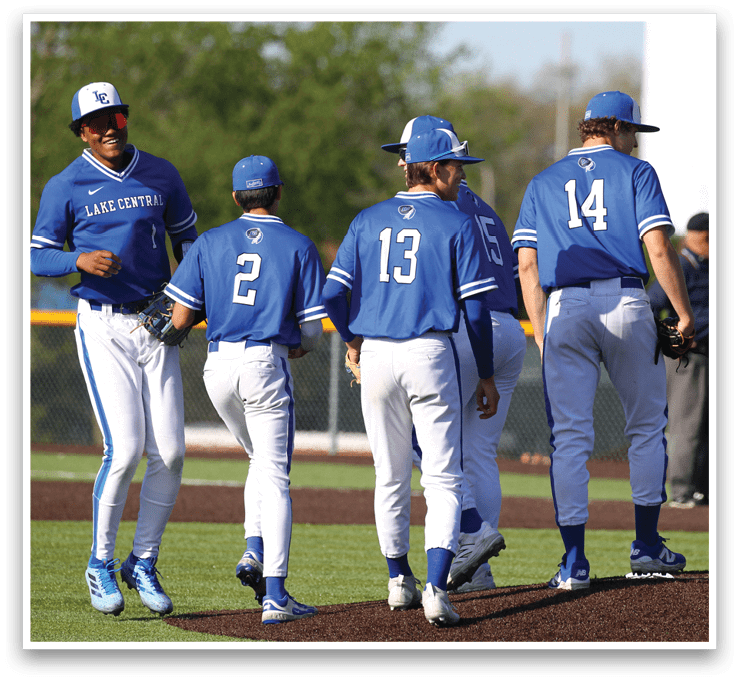 A group of baseball players wearing blue uniforms. Description generated by AI