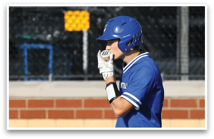 A baseball player wearing a blue helmet and blue and white uniform. Description generated by AI