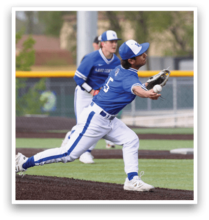 A baseball player wearing a blue shirt and white pants is throwing a ball. Description generated by AI