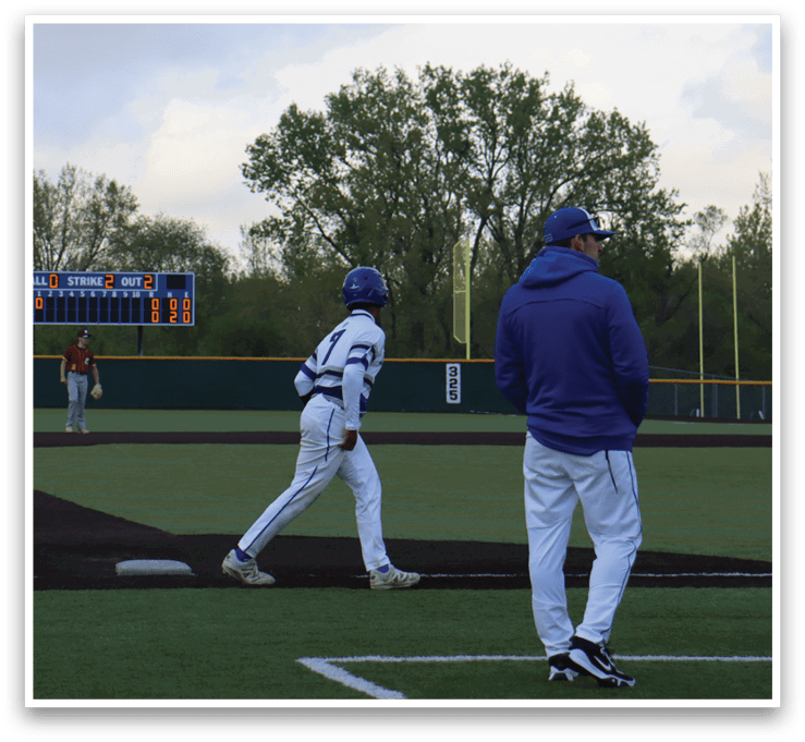 A baseball game is taking place with a group of people playing. Description generated by AI