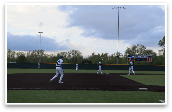 A baseball field with three players on it. Description generated by AI