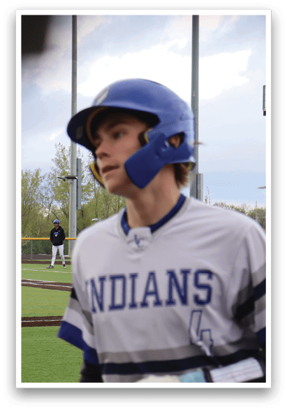 A baseball player wearing a blue helmet. Description generated by AI