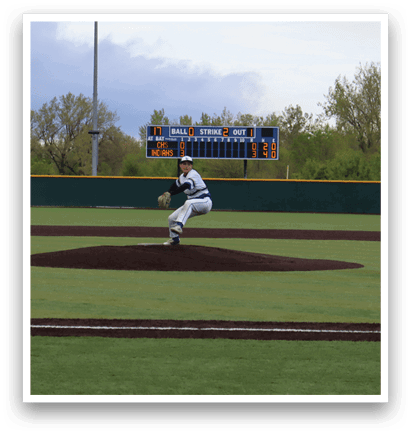 A baseball player is pitching a ball on a field. Description generated by AI