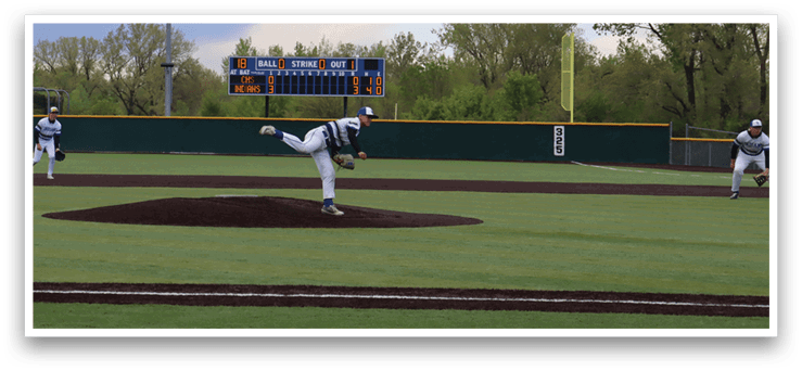 A baseball player is pitching a ball on a field. Description generated by AI
