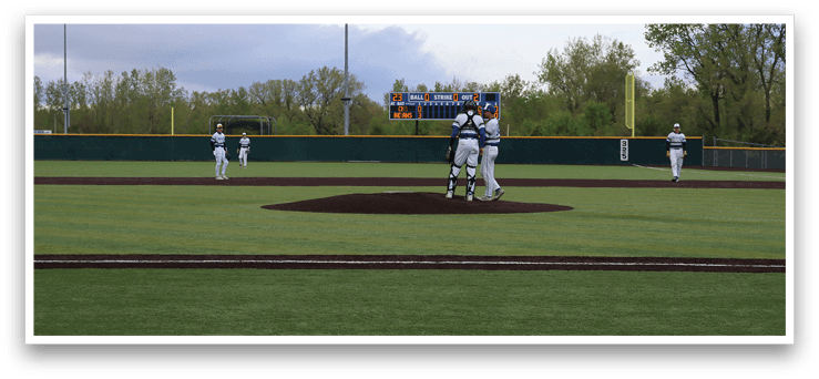 A baseball field with a pitcher and catcher. Description generated by AI