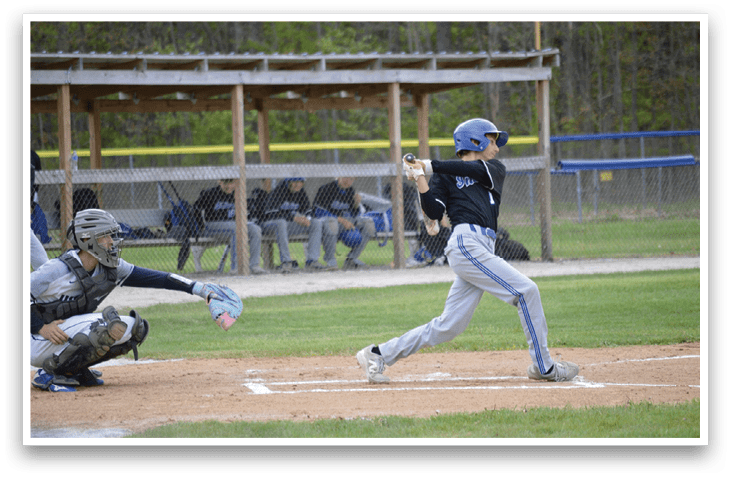A baseball player is swinging a bat at a ball. Description generated by AI
