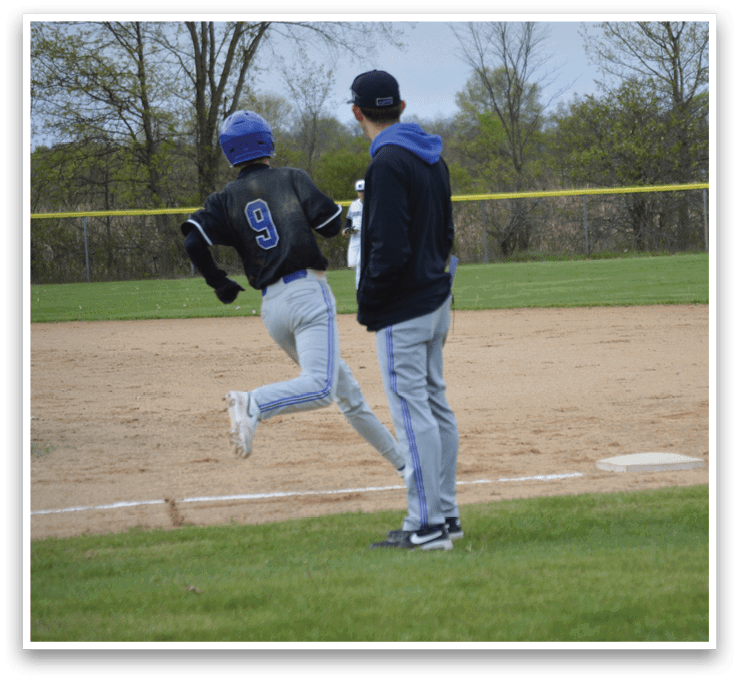 A boy wearing a blue helmet is running on a baseball field. Description generated by AI