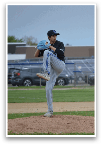 A baseball player in a black shirt and blue hat is pitching a ball. Description generated by AI