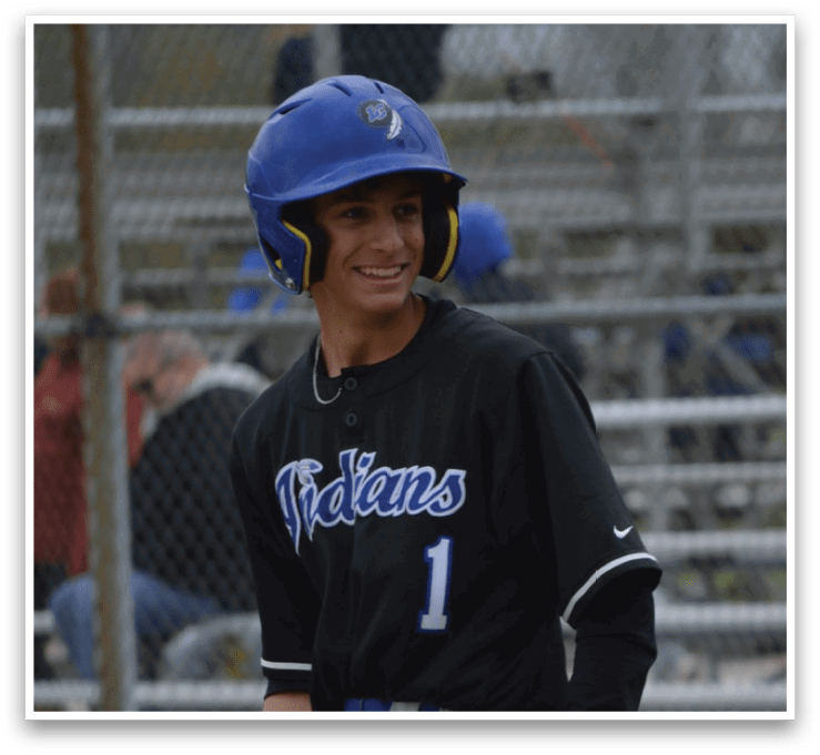 A baseball player holding a bat. Description generated by AI