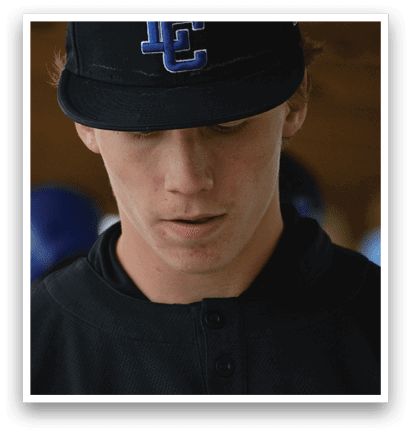 A man wearing a black hat with a blue C on it. Description generated by AI