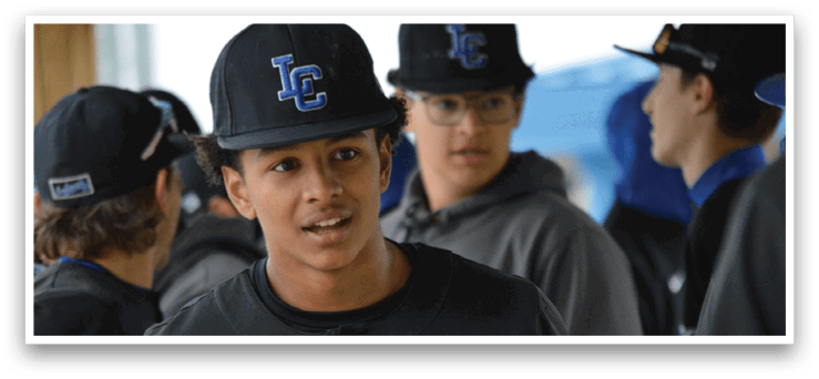 A young man wearing a baseball uniform with the word Indians on the front. Description generated by AI