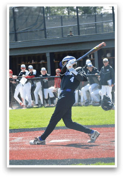 A baseball player is swinging a bat on a field. Description generated by AI