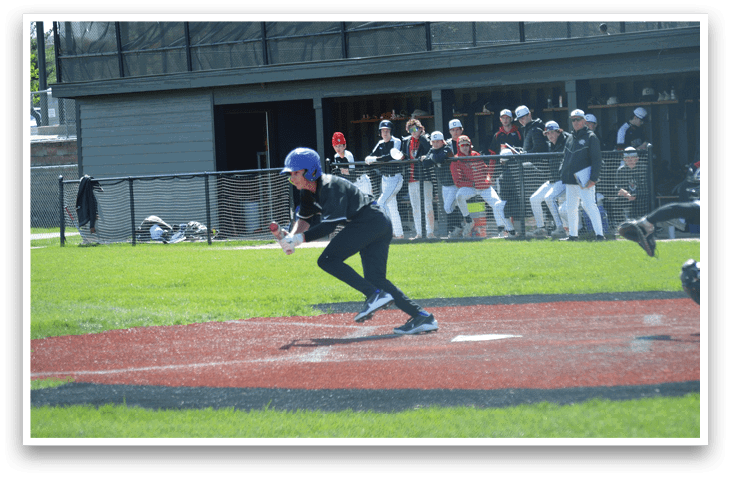 A baseball player is swinging a bat on a field. Description generated by AI