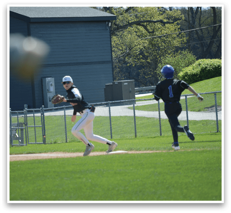 A baseball player wearing a blue helmet and white uniform running to a base. Description generated by AI