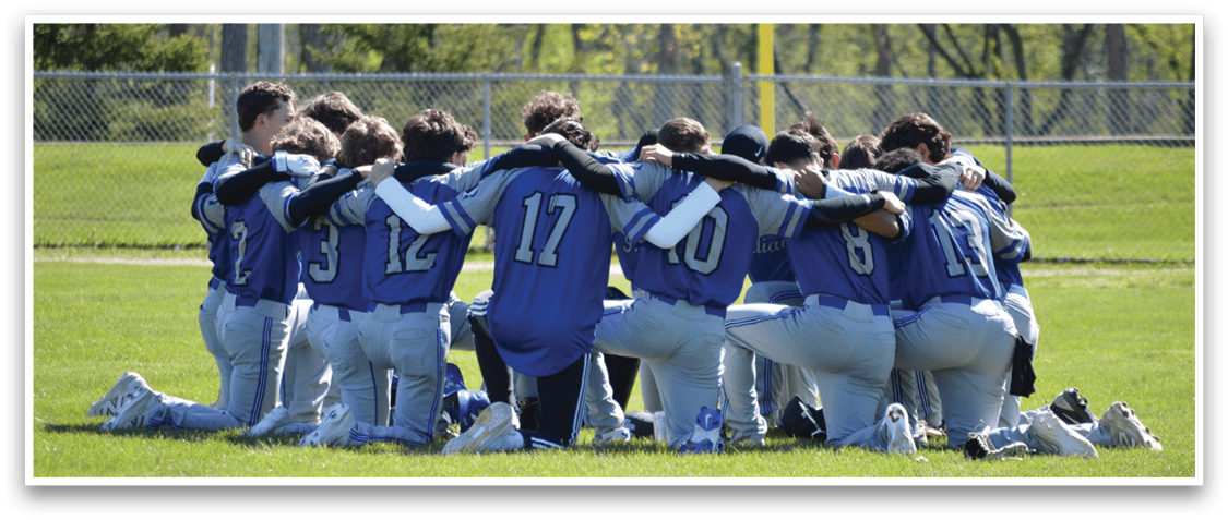 A group of baseball players huddled together on the field. Description generated by AI