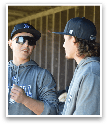 Two men wearing sunglasses and hoodies. Description generated by AI