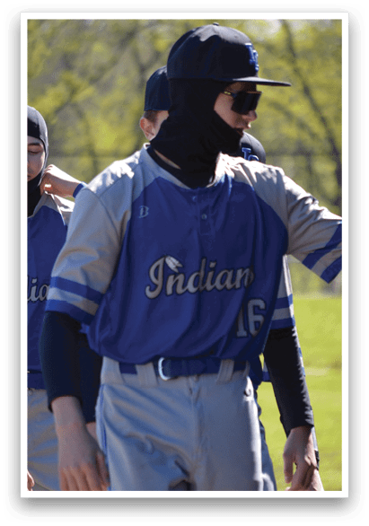 A group of baseball players wearing blue and grey uniforms. Description generated by AI