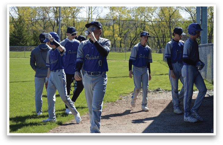 Baseball players walking on a field. Description generated by AI