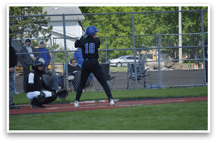 A baseball player is up to bat, wearing a blue helmet. Description generated by AI