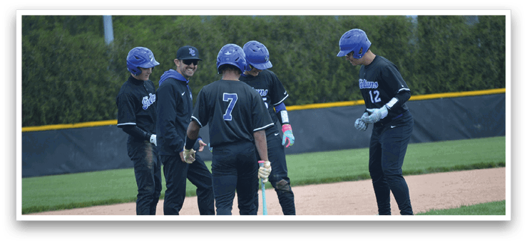 Baseball players wearing black and blue uniforms. Description generated by AI