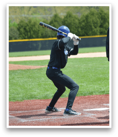 A baseball player is at bat, holding a bat and getting ready to swing. Description generated by AI