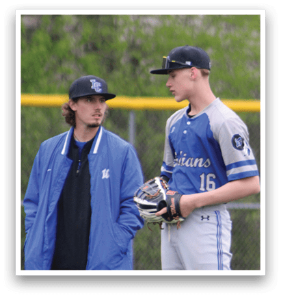 A baseball player wearing a blue and white uniform. Description generated by AI