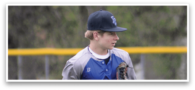 A baseball player wearing a blue and white uniform. Description generated by AI