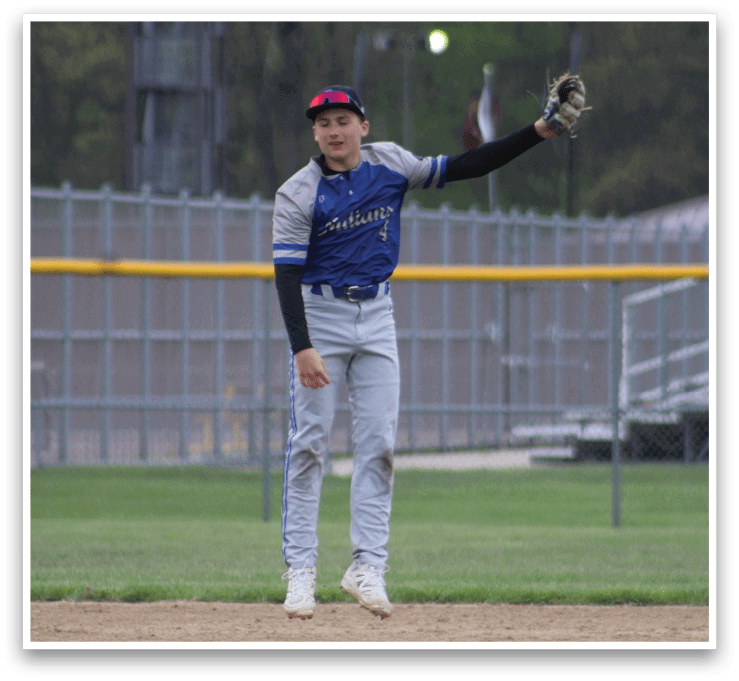 A baseball player is standing on the field with his glove on. Description generated by AI