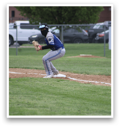A baseball player is kneeling on the ground with his glove on. Description generated by AI