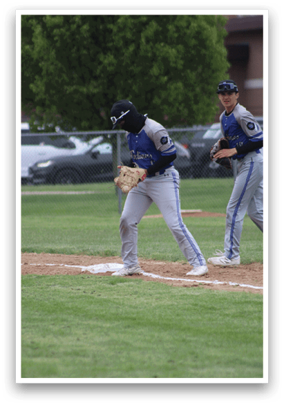 A baseball player is holding a bat and standing at home plate. Description generated by AI
