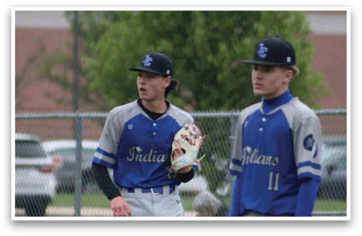 Three baseball players standing on a field. Description generated by AI