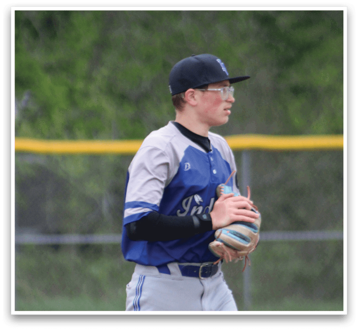 A baseball player wearing a blue and gray uniform. Description generated by AI