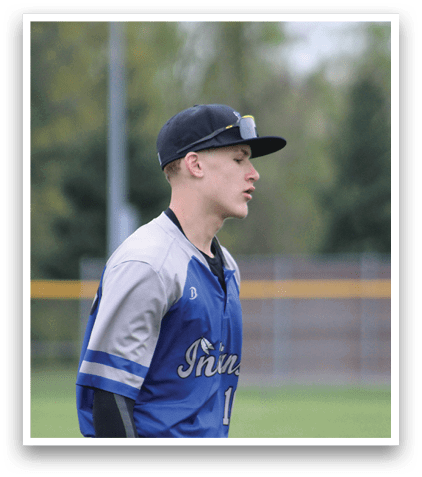 A baseball player wearing a blue and grey uniform. Description generated by AI