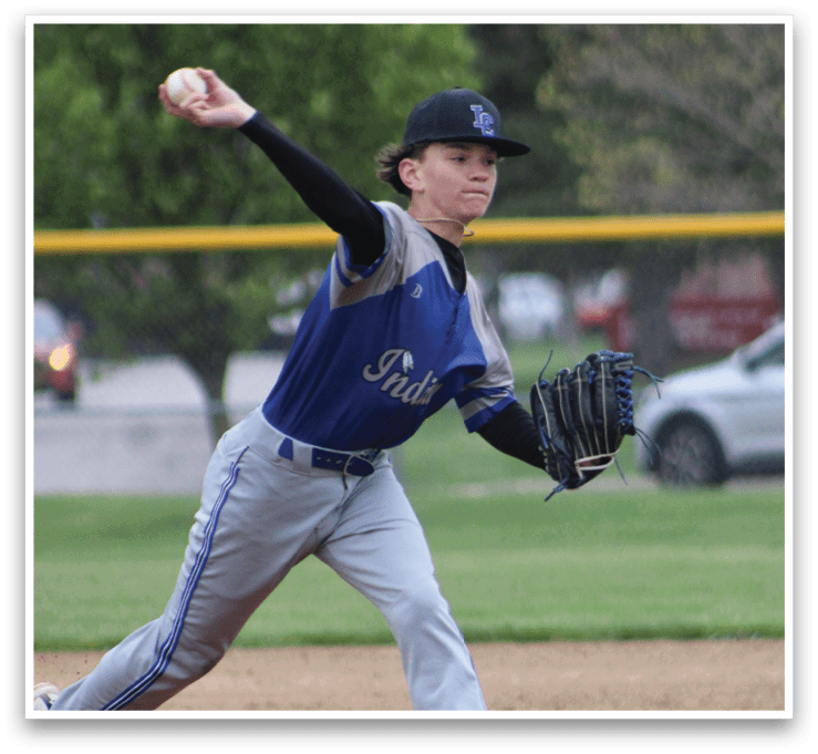 A baseball player in a blue and white uniform is throwing a ball. Description generated by AI