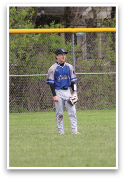 A baseball player standing in the outfield. Description generated by AI