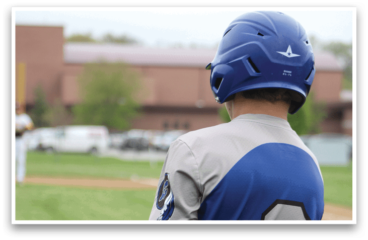 A baseball player wearing a blue and white uniform. Description generated by AI