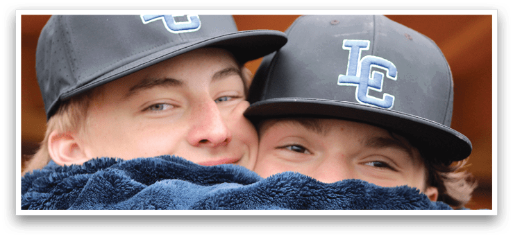 Two people wearing black hats. Description generated by AI