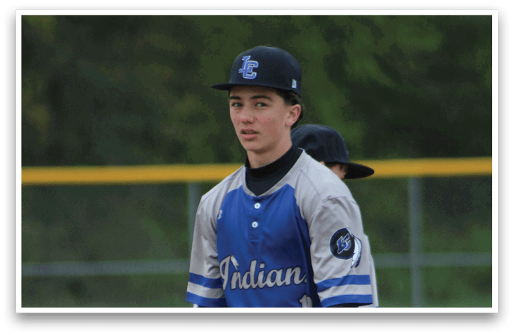 A baseball player wearing a blue and white uniform. Description generated by AI