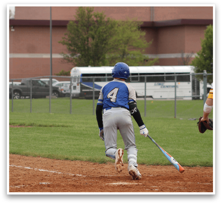 A baseball player with the number 2 on his back is holding a bat and standing on a field. Description generated by AI