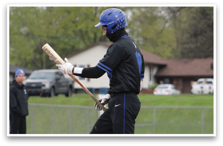 A baseball player is swinging a bat at a ball. Description generated by AI