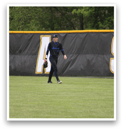 A baseball player wearing a blue shirt and black pants is standing on a baseball field. Description generated by AI