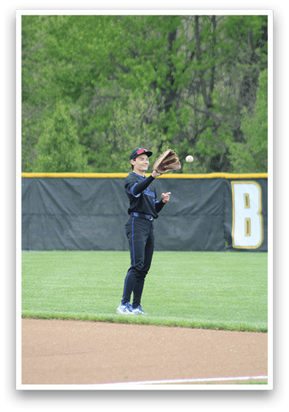 A baseball player catching a ball. Description generated by AI