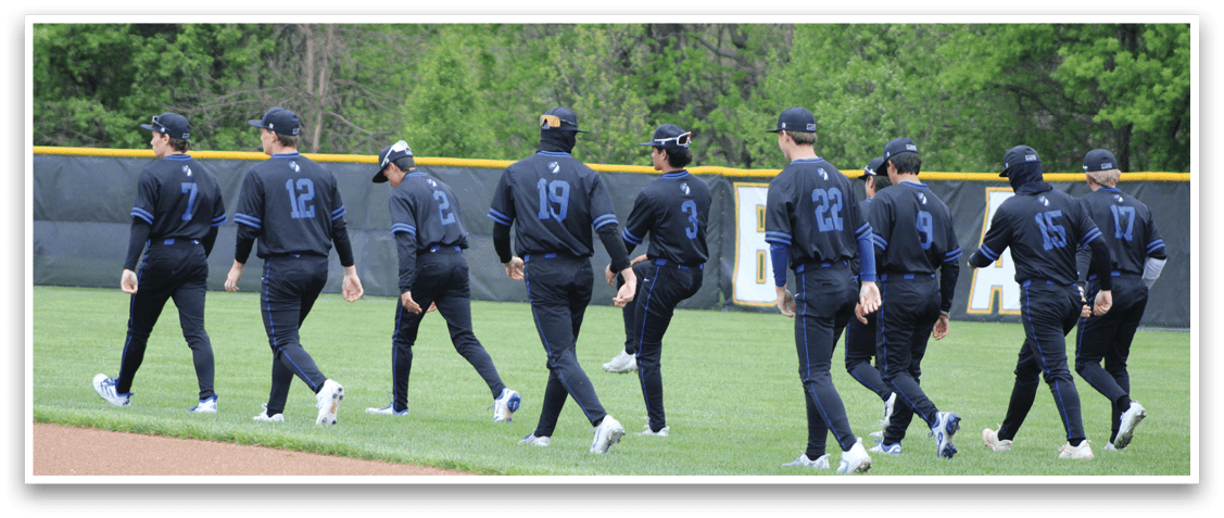 A group of baseball players walking on the field. Description generated by AI