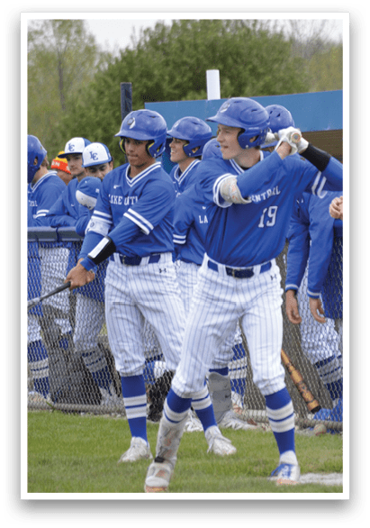 Baseball players wearing blue and white uniforms. Description generated by AI