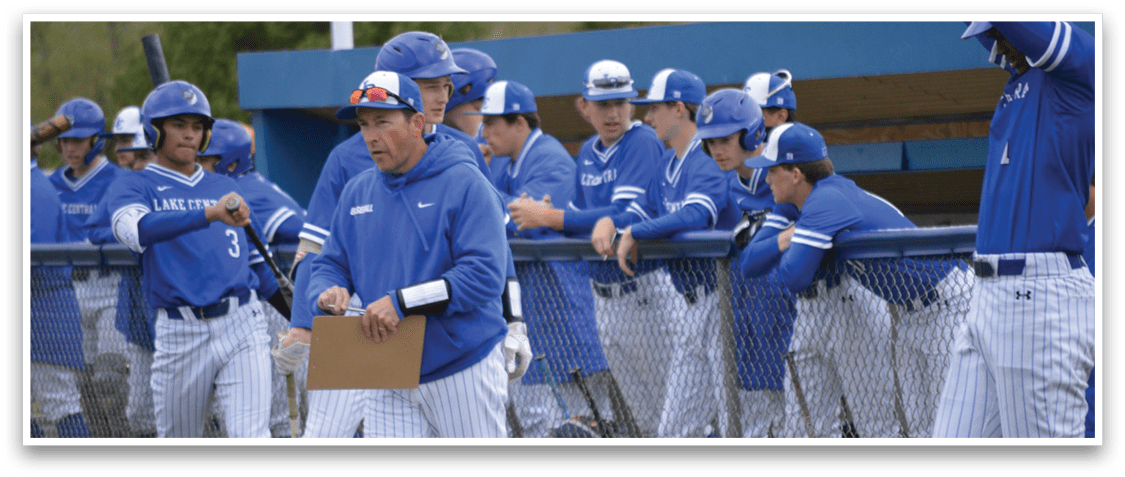 A baseball coach is talking to his team. Description generated by AI