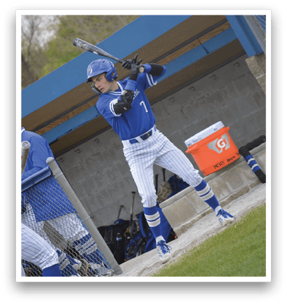 A baseball player is holding a bat and getting ready to hit a ball. Description generated by AI