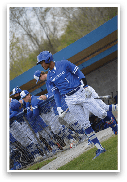 A baseball player wearing a blue and white uniform. Description generated by AI