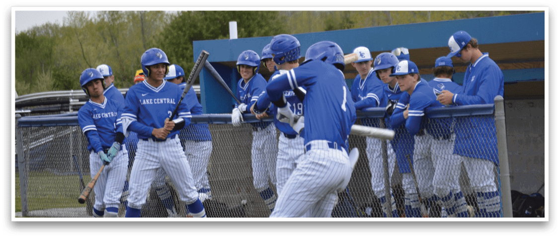 A baseball player in a blue and white uniform is swinging a bat. Description generated by AI