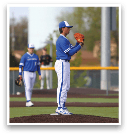 A baseball player wearing a blue uniform and a red glove. Description generated by AI